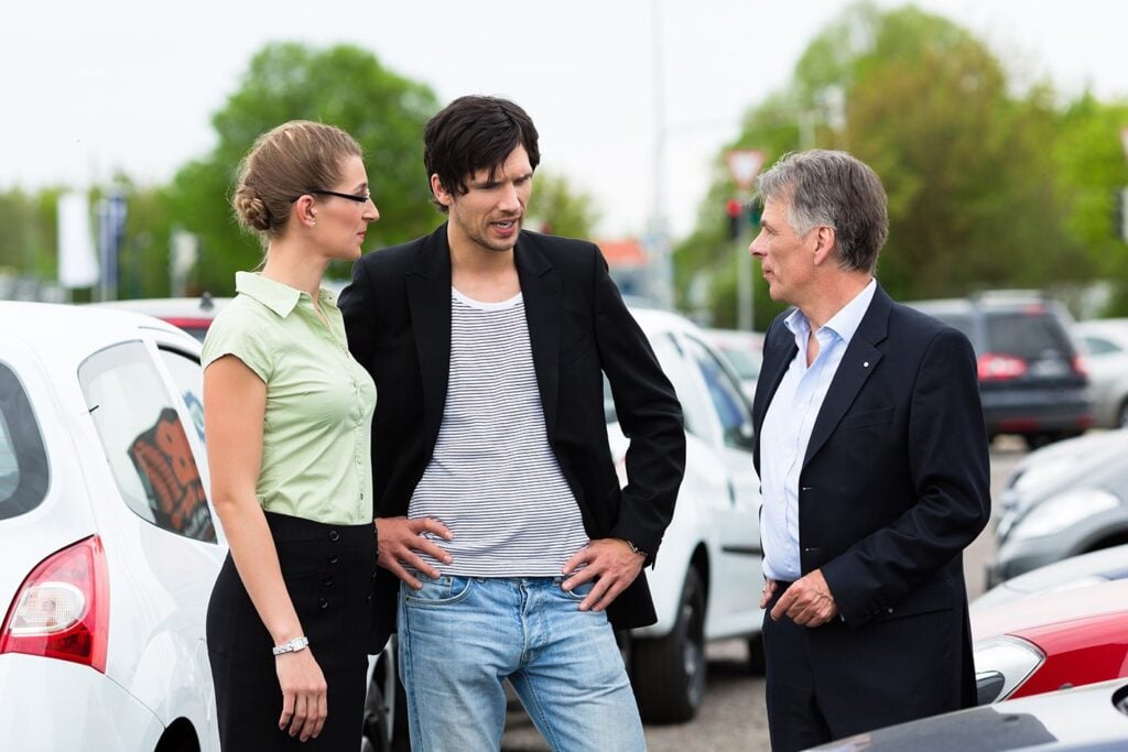 person talking to car dealer