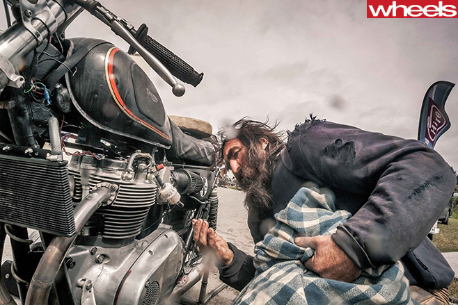 Motorbike -rider -checking -bike
