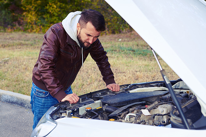 Man looking at engine bay