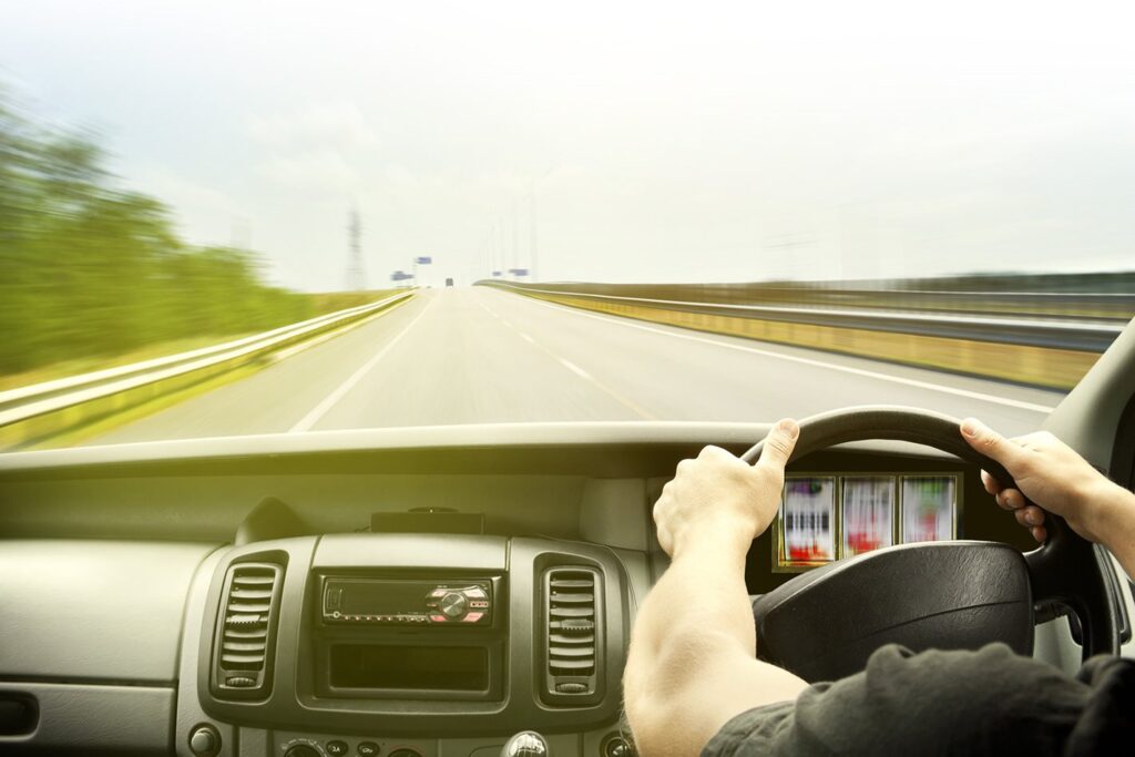 Man driving a car at speed