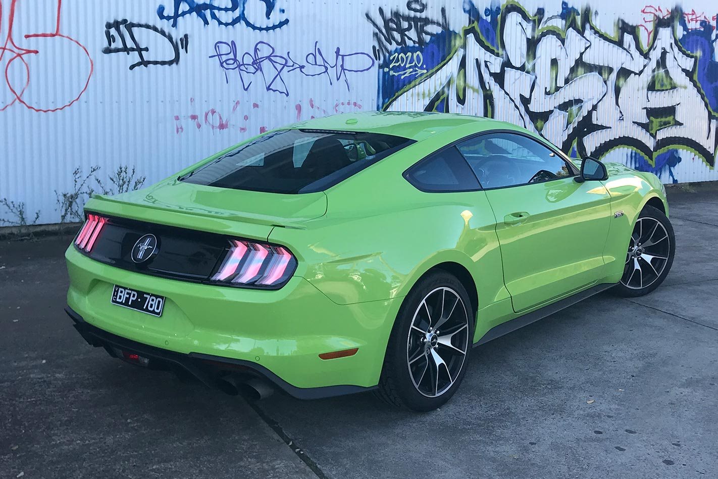Ford Mustang 2.3L High Performance parked in front of graffiti