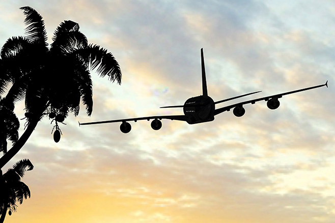 Airplane Flying Over Sunset