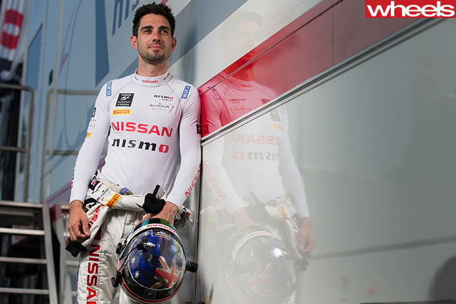 Shane Van Gisbergen leaning -against -wall