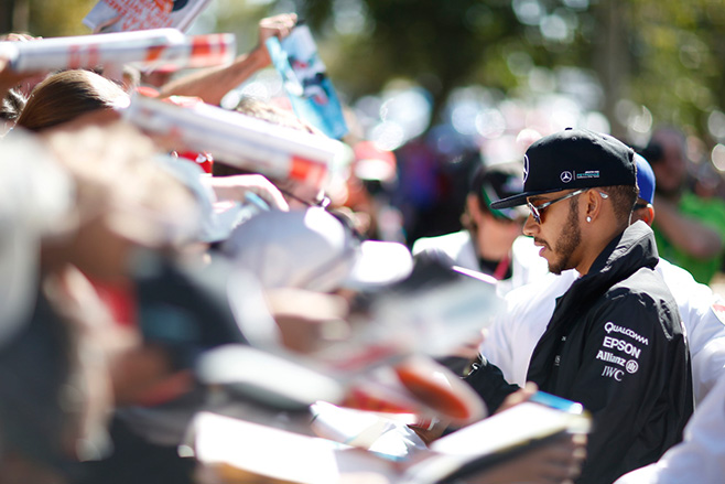 Lewis Hamilton signing things