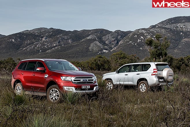 Everest -v -Prado -side -parked -field