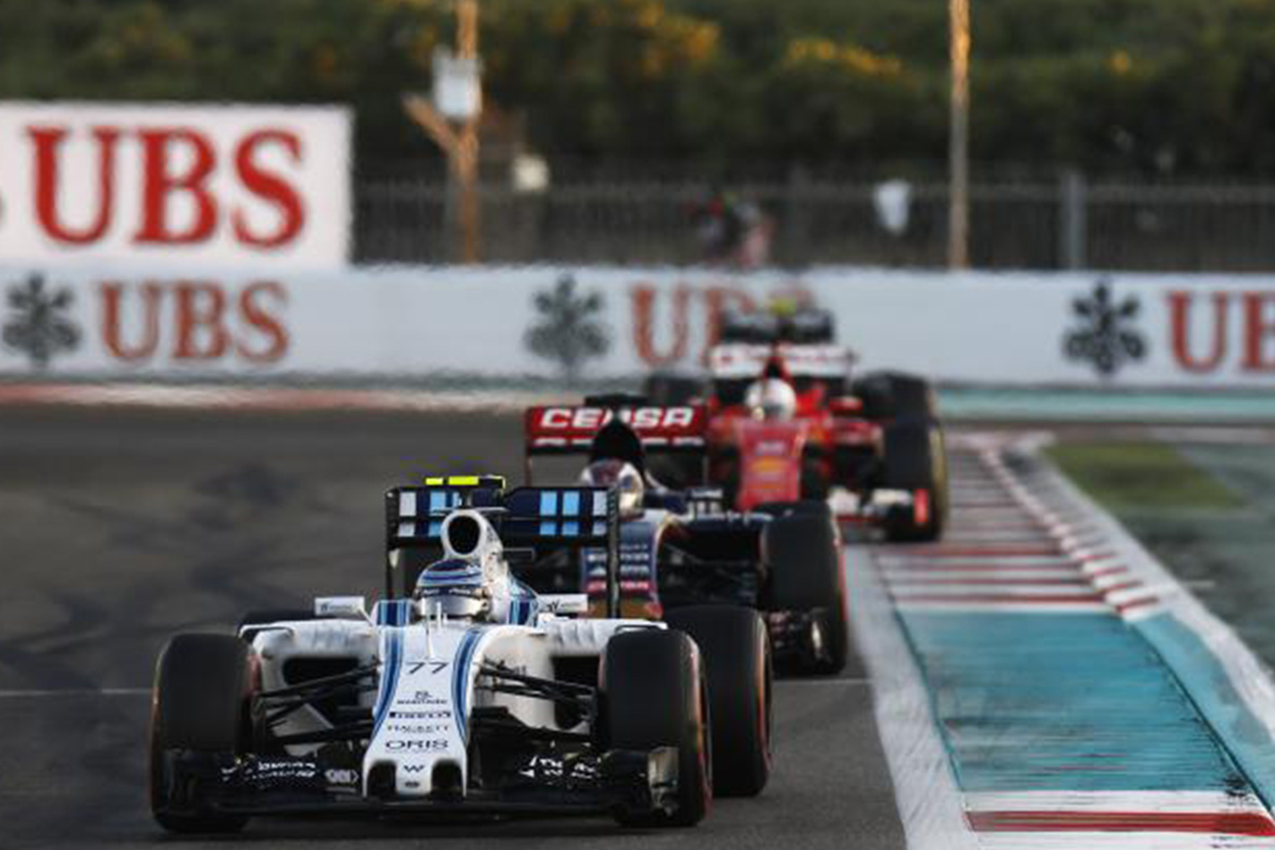 F1 drivers racing around corner