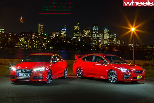 Audi -S3-vs -Subaru -WRX-STi --parked -in -front -of -city