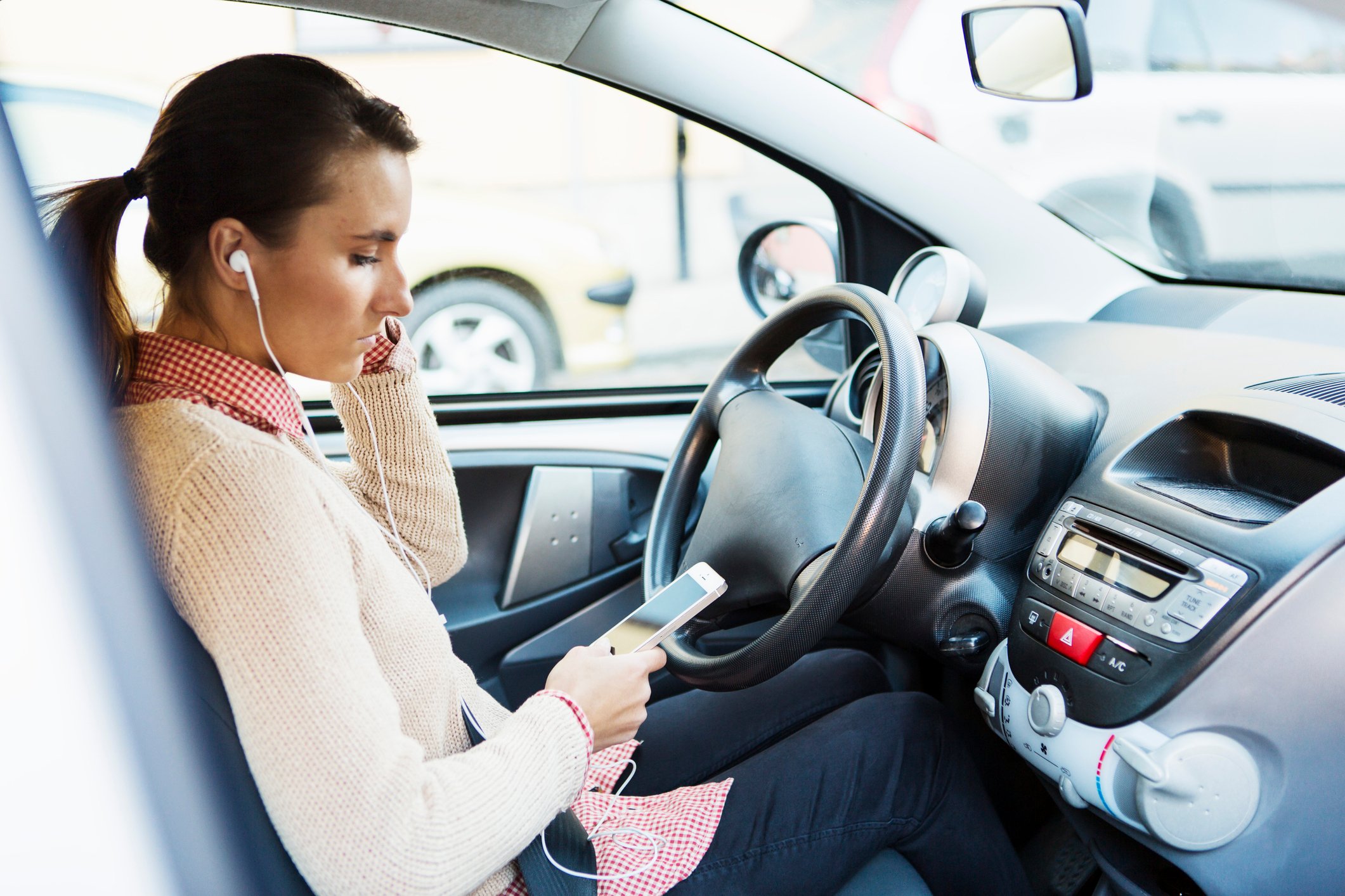 is using airpods in a car illegal