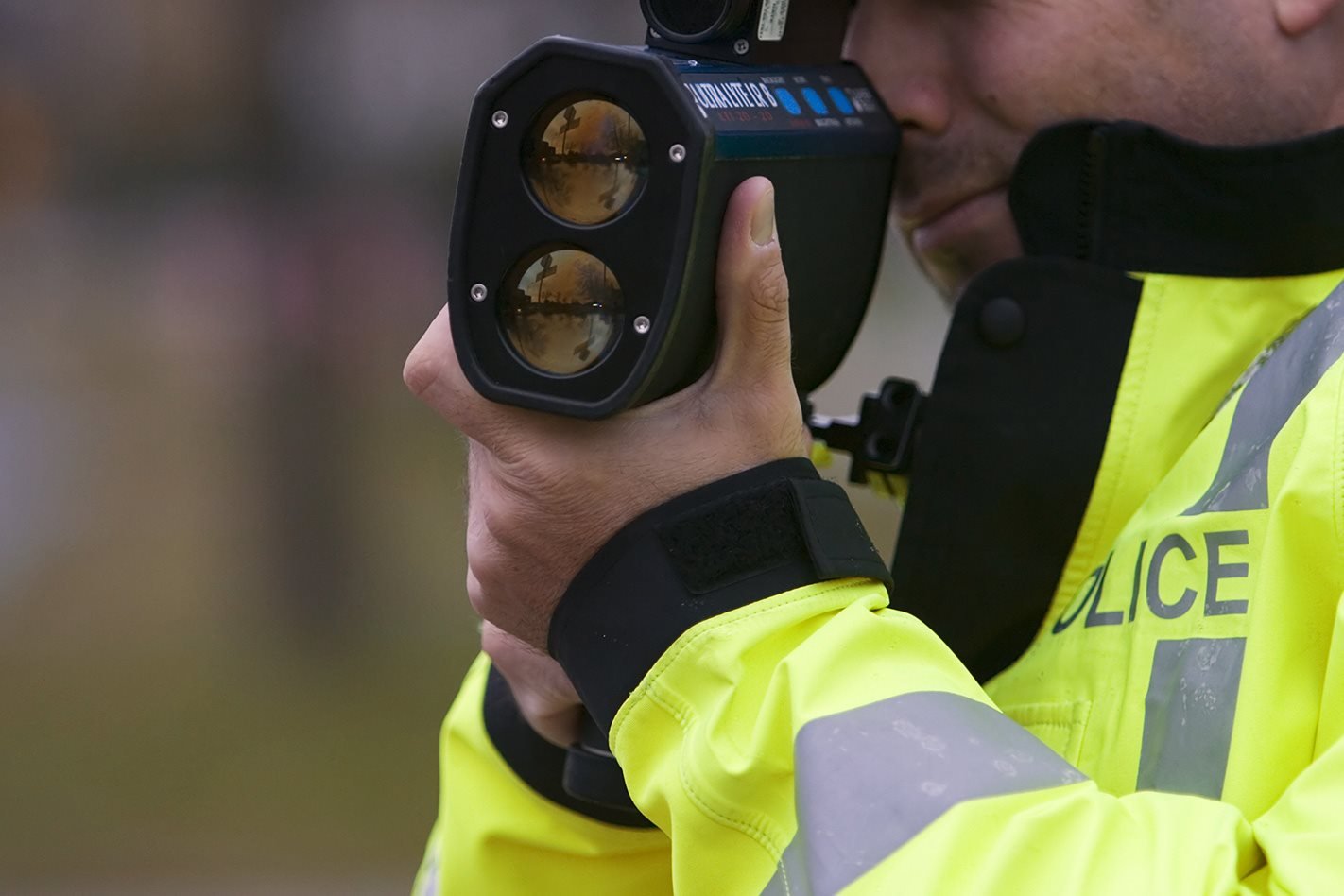 Police officer with speed trap gun