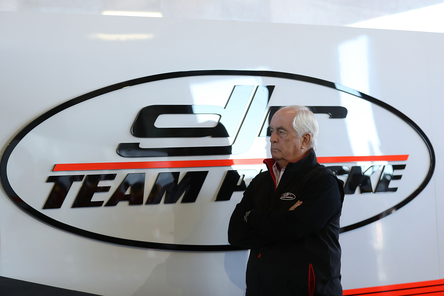 Roger Penske with Penske Group logo