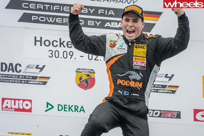 Joey -Mawson -flexing -on -podium