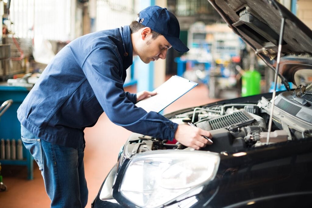 Mechanic servicing car