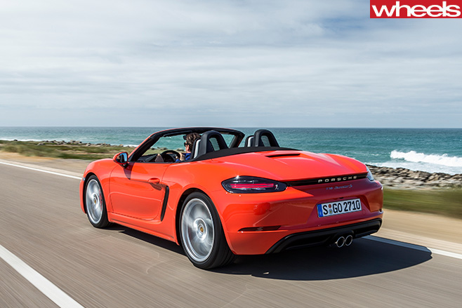 Orange -Porsche -918-Boxster -S-driving -rear -side