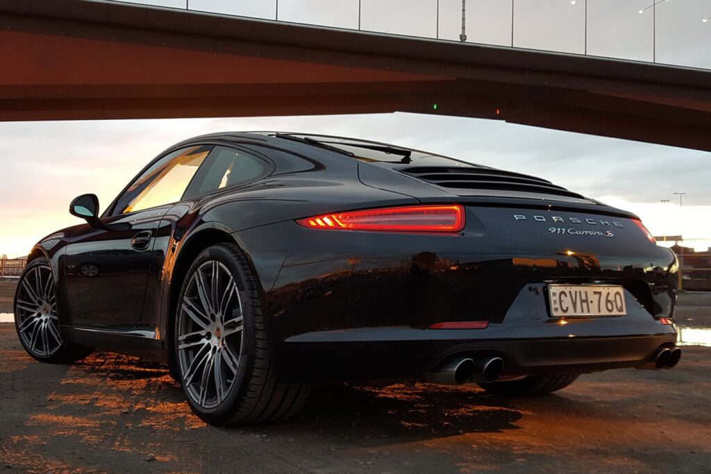 Porsche 911 Carrera S parked under bridge