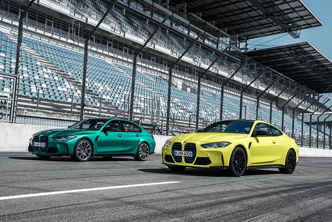 BMW M3 Competition and M4 Competition parked together.