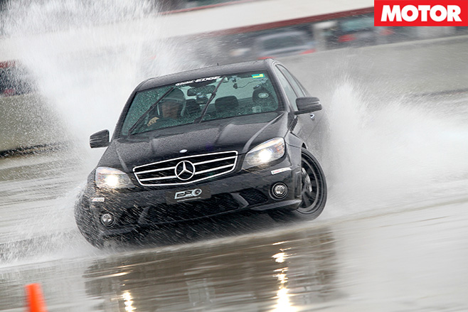 Black merc driving hard