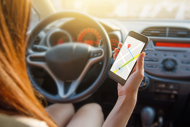 Woman using Google Maps while in car