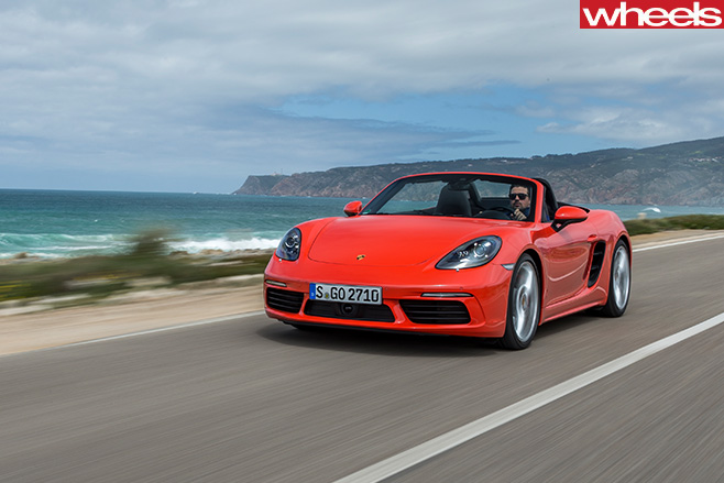 Orange -Porsche -918-Boxster -S-driving -side -front