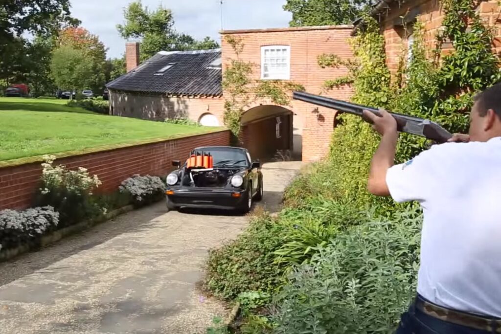 Professional marksman shooting at 911 Targa clay pigeons