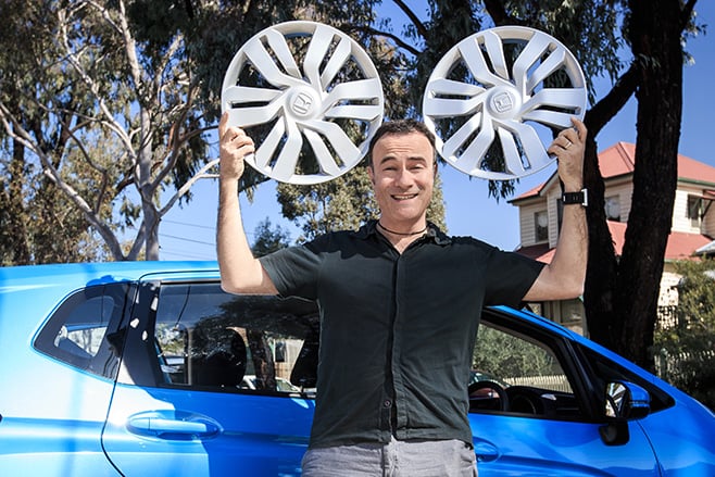 Byron holding Honda Jazz hub caps