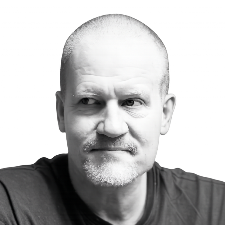 Black-and-white portrait of a middle-aged man with short hair and light beard, looking to the left.