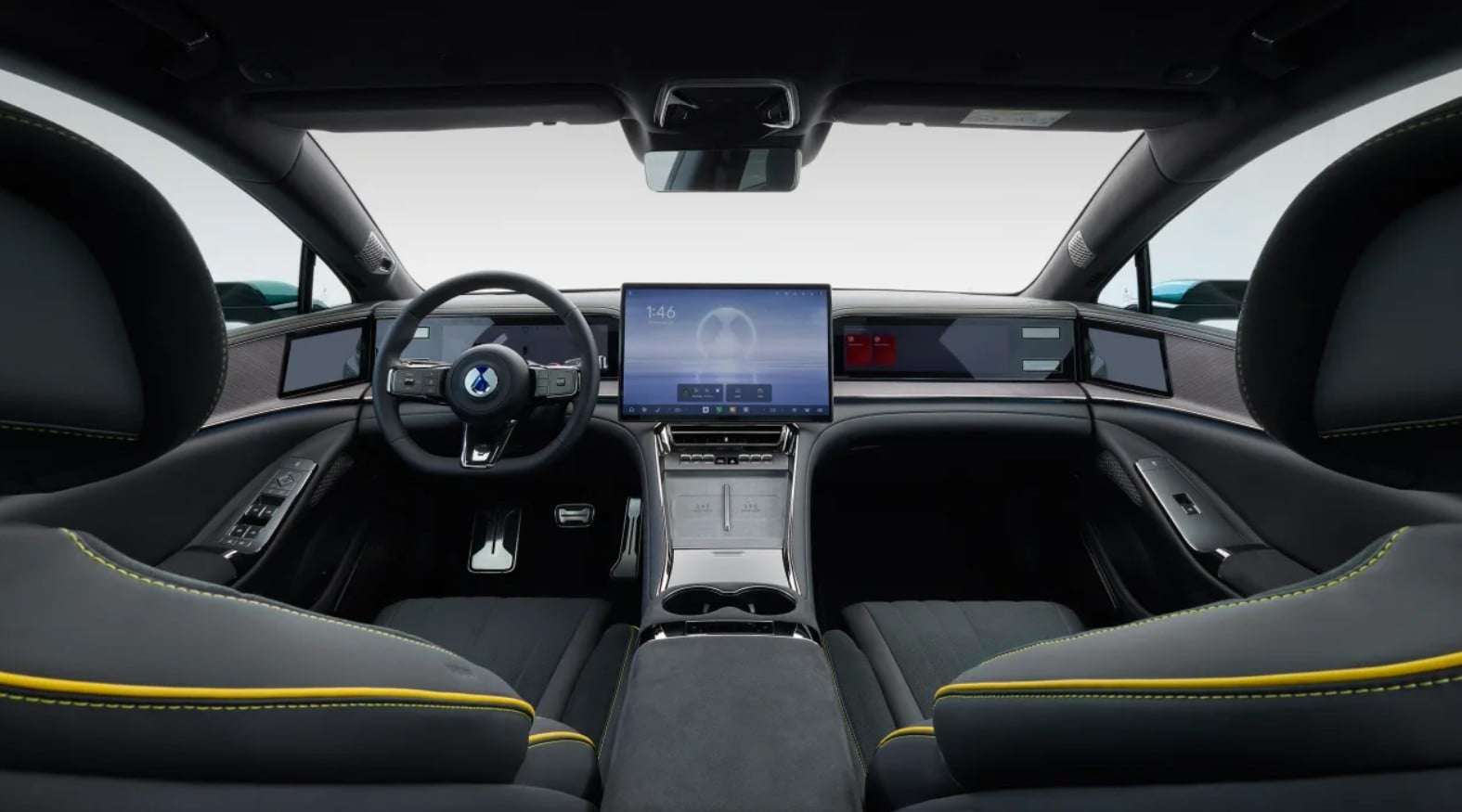 Luxurious car interior with a large center touchscreen, digital dash, and black leather seats with yellow stitching.