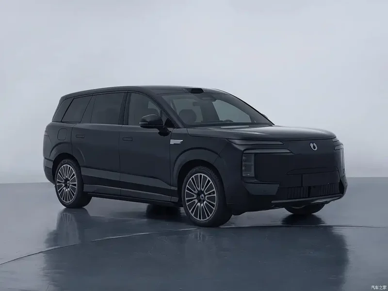 Black three-row SUV parked in a white studio, showing its sleek, modern design.
