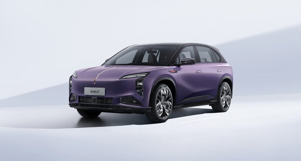 Front-left three-quarter view of a purple electric SUV in a clean white studio setting, with 'EHS7' on the license plate.
