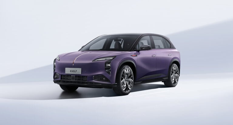 Front-left three-quarter view of a purple electric SUV in a clean white studio setting, with 'EHS7' on the license plate.