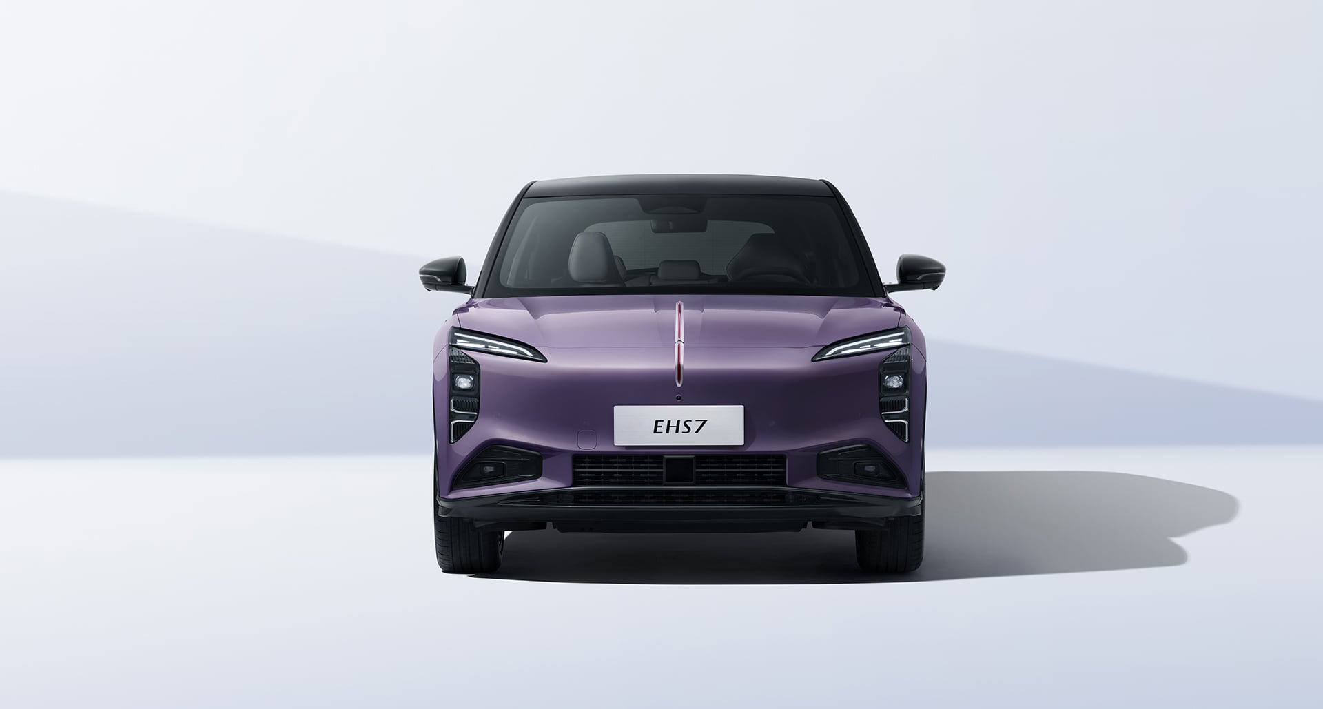 Front view of a purple SUV with a black roof, modern LED headlights, and a silver license plate reading EHS7 on a neutral backdrop.