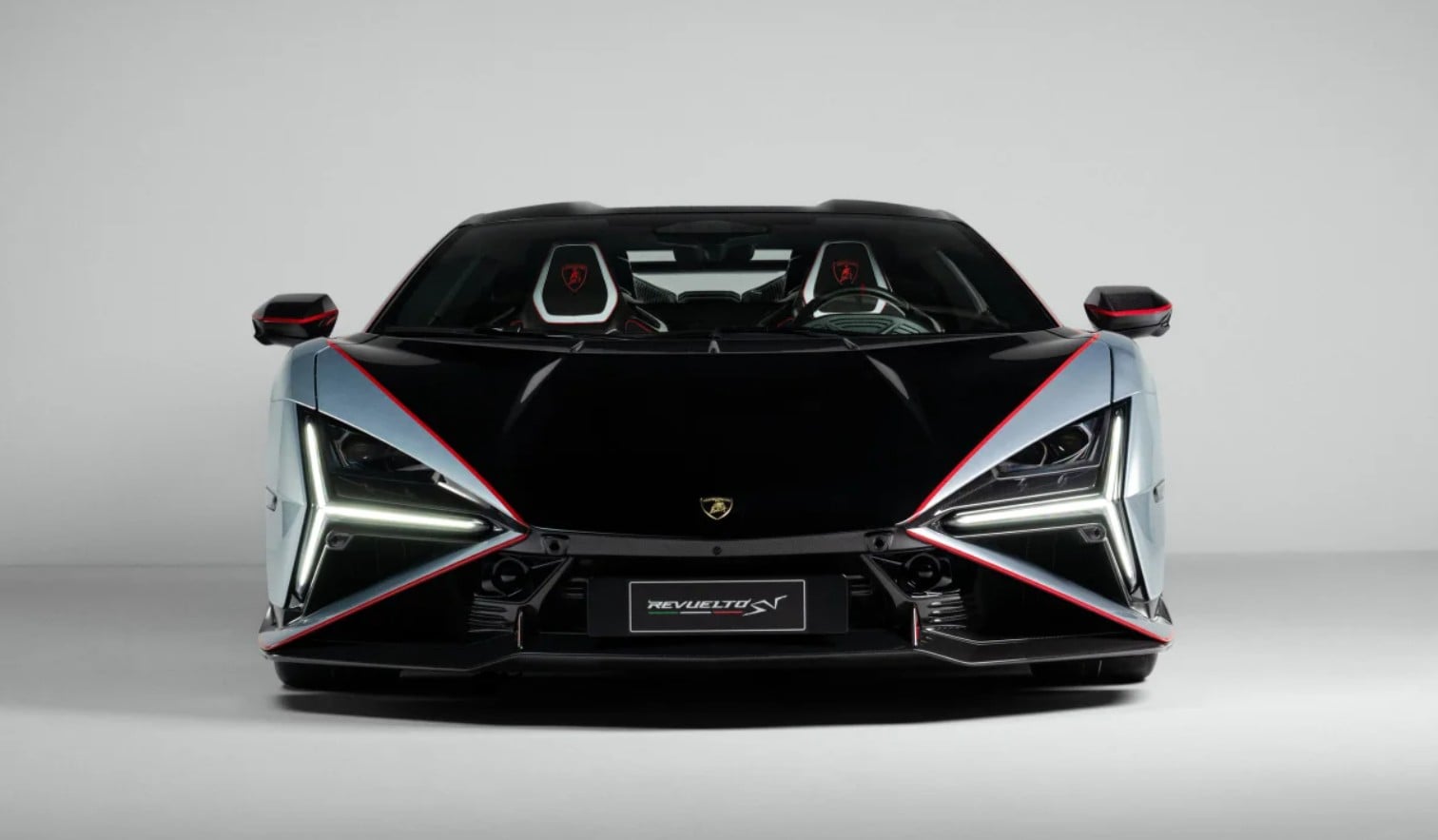 Front view of a black Lamborghini Revuelto with silver panels and red accent lines along the edges.