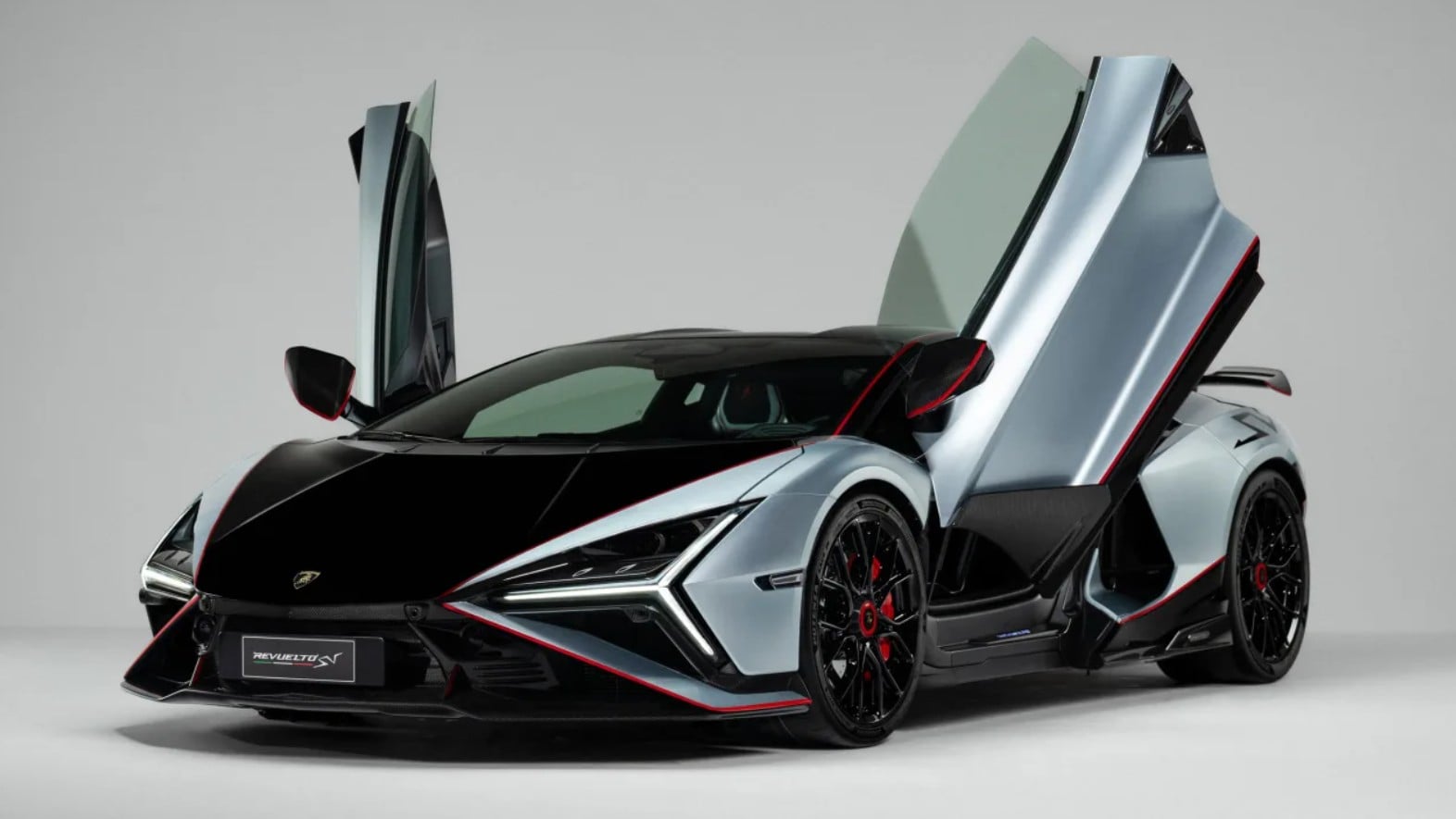 Lamborghini two-tone sports car with butterfly doors open, red trim accents, on a neutral studio background.