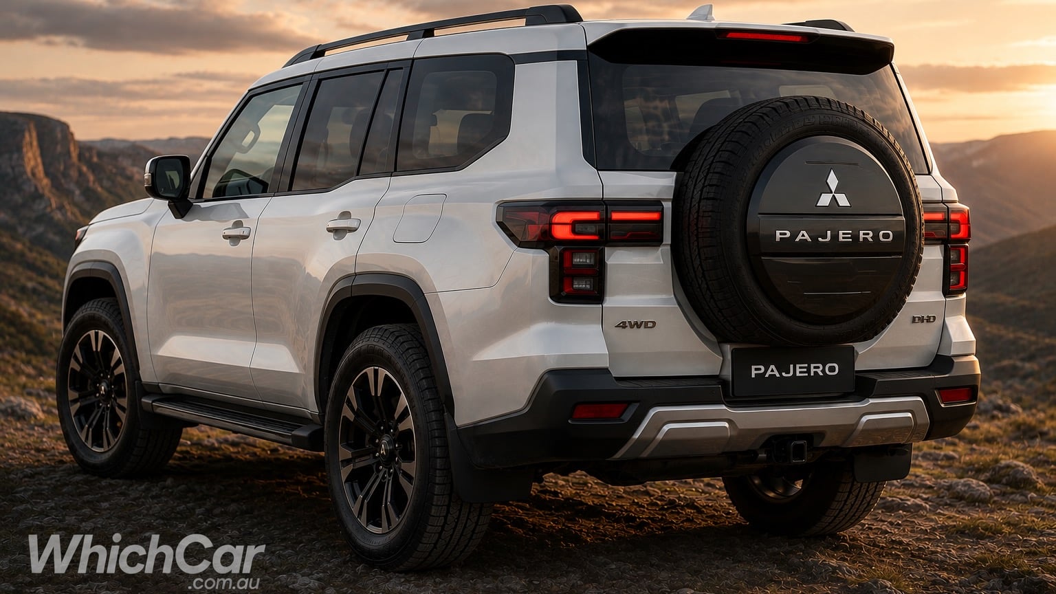 Rear-left view of a white Mitsubishi Pajero SUV on rocky terrain at sunset, spare tire mounted on the back with Pajero branding.
