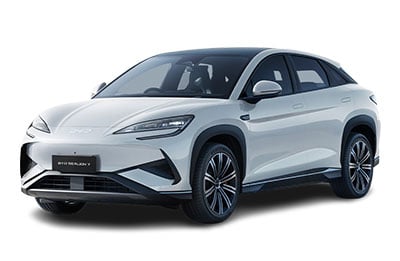 White electric crossover SUV seen from the front-left, showing sleek headlights and sculpted bumper.