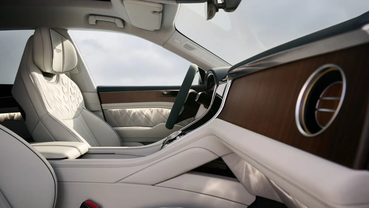 Luxurious car interior with cream leather seats and wood dashboard trim in a premium sedan