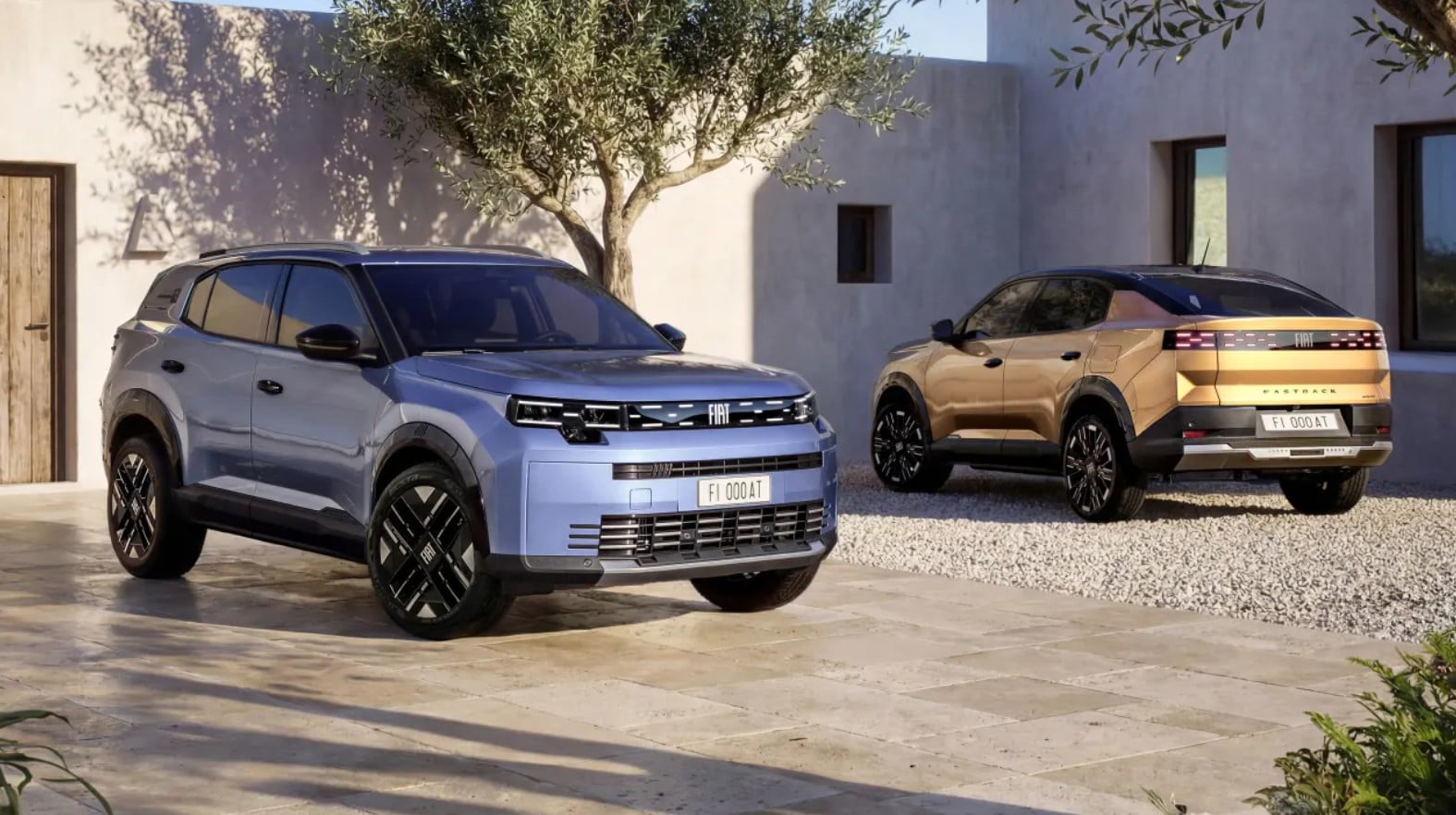Two Fiat SUVs parked in a light-colored courtyard with a modern stucco house and olive tree in the background—the front blue vehicle and a tan rear vehicle.