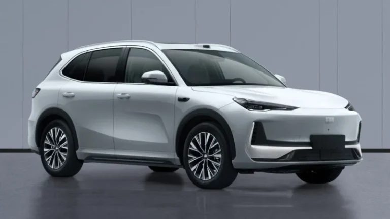 White mid-size SUV in a showroom setting, featuring sleek lines, alloy wheels, and roof rails, viewed from the front-left side.