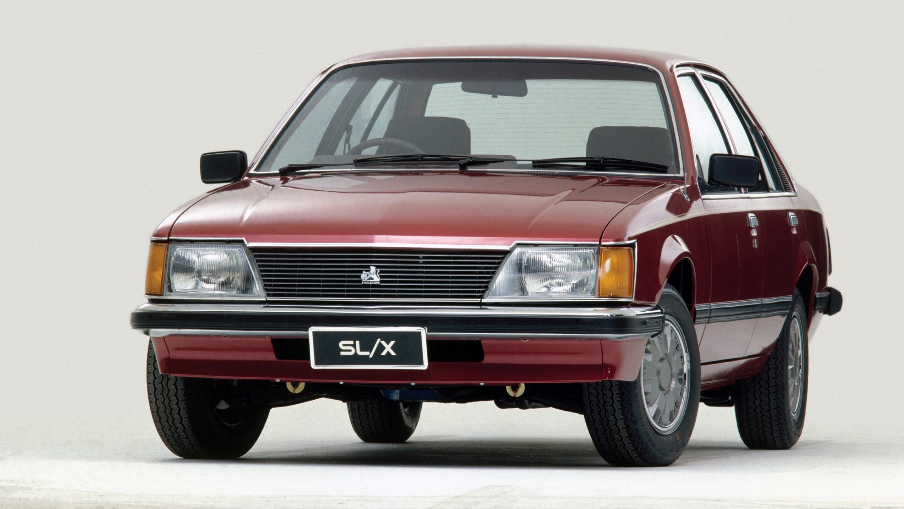 Front view of a red classic Holden SL/X car with grille emblem and visible headlights.