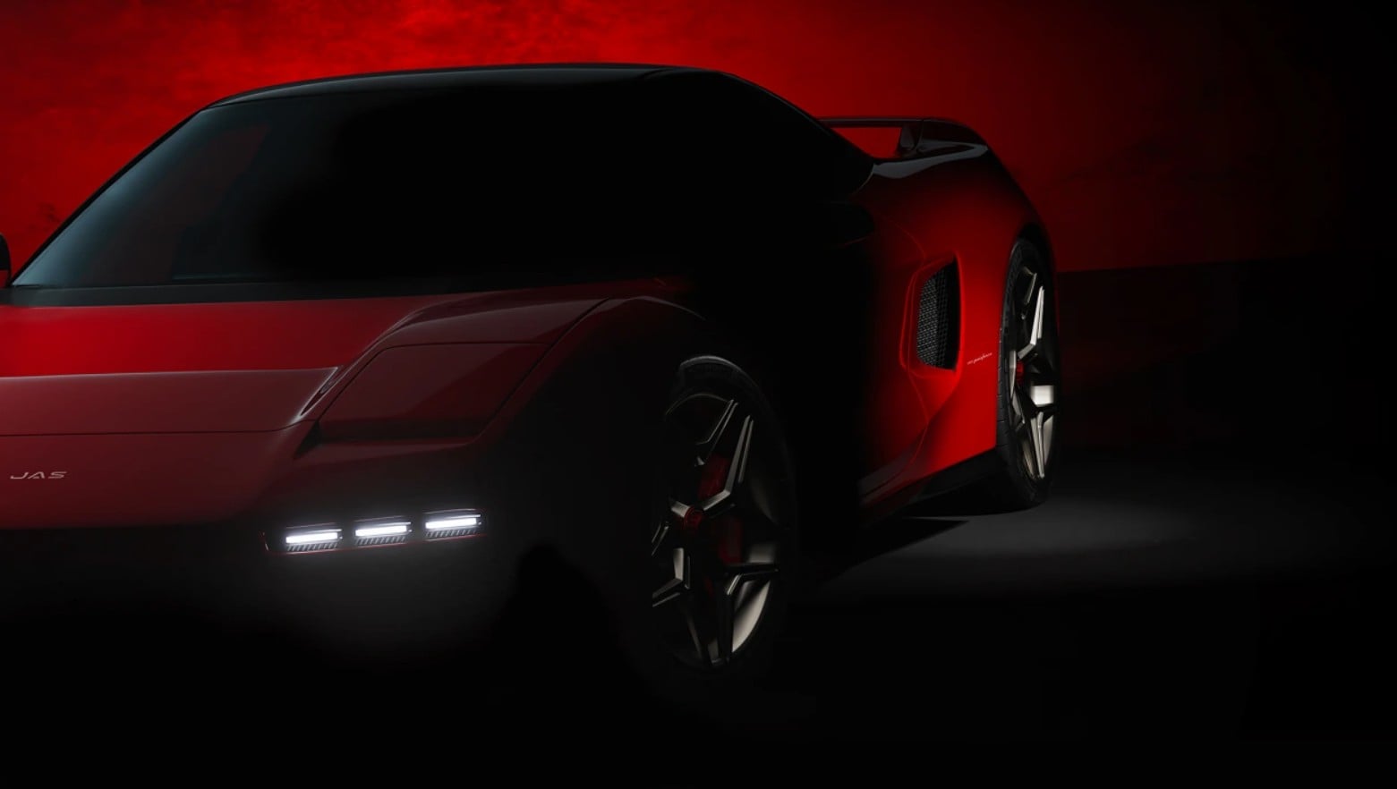 Red high-performance sports car shown from the side in a dark studio, dramatic red glow in the background and low lighting on its contours.