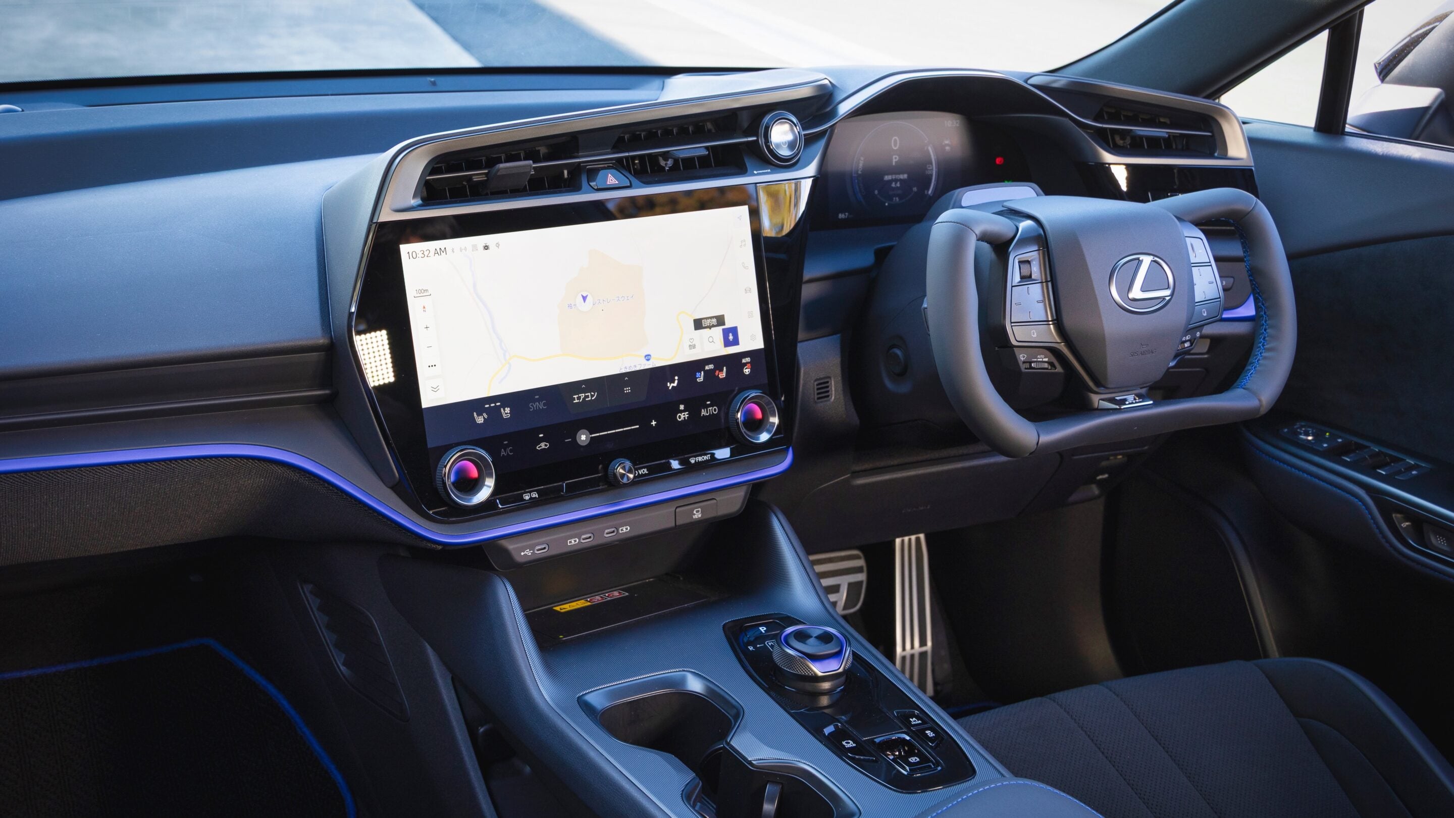 Luxurious car interior with a large central touchscreen displaying a navigation map and climate controls