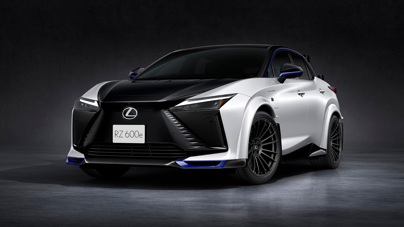 Front three-quarter view of a white and black Lexus SUV with blue accent lighting and large alloy wheels.