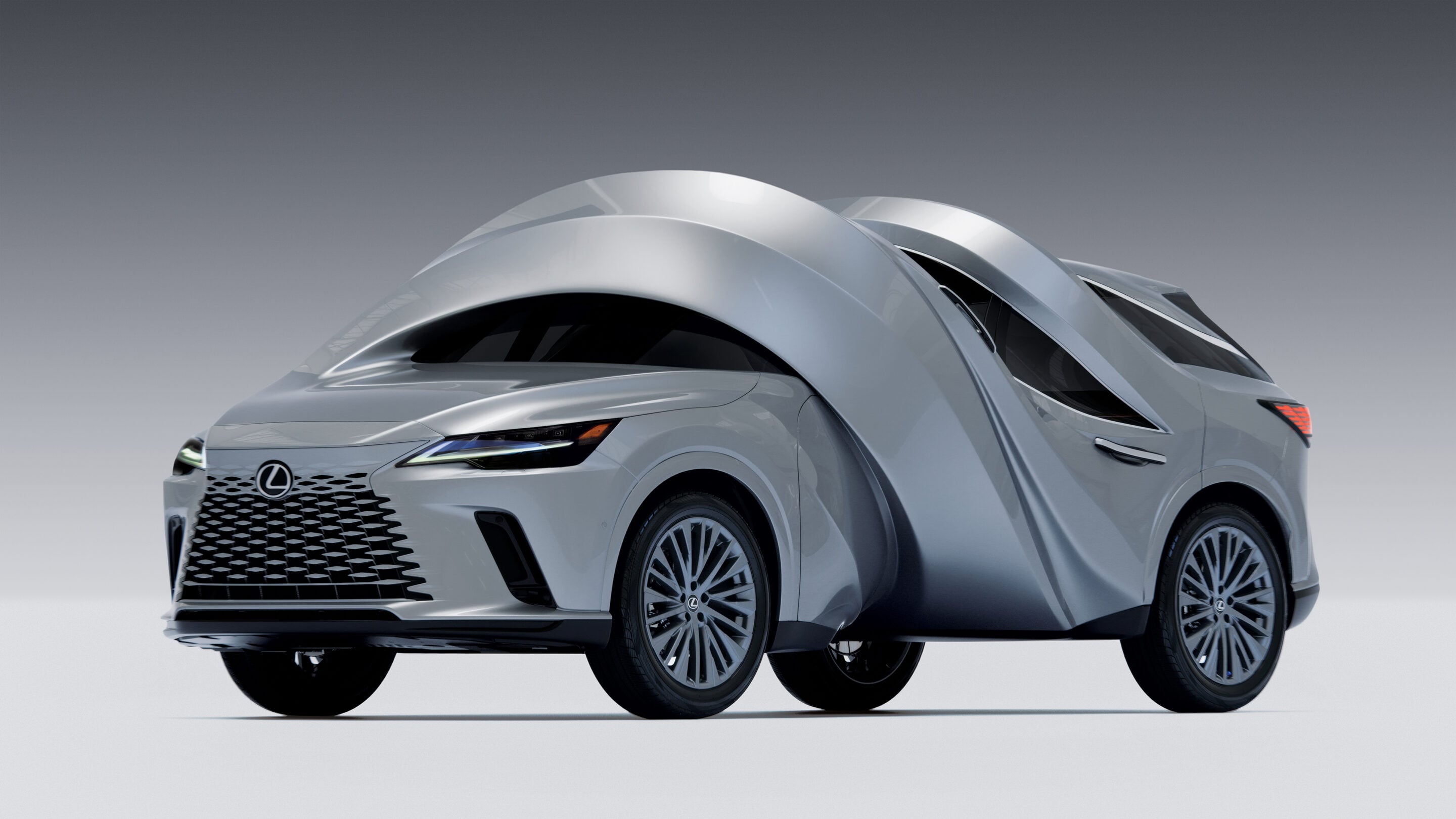 Sleek silver concept car with sweeping curved roof panels and a prominent grille.