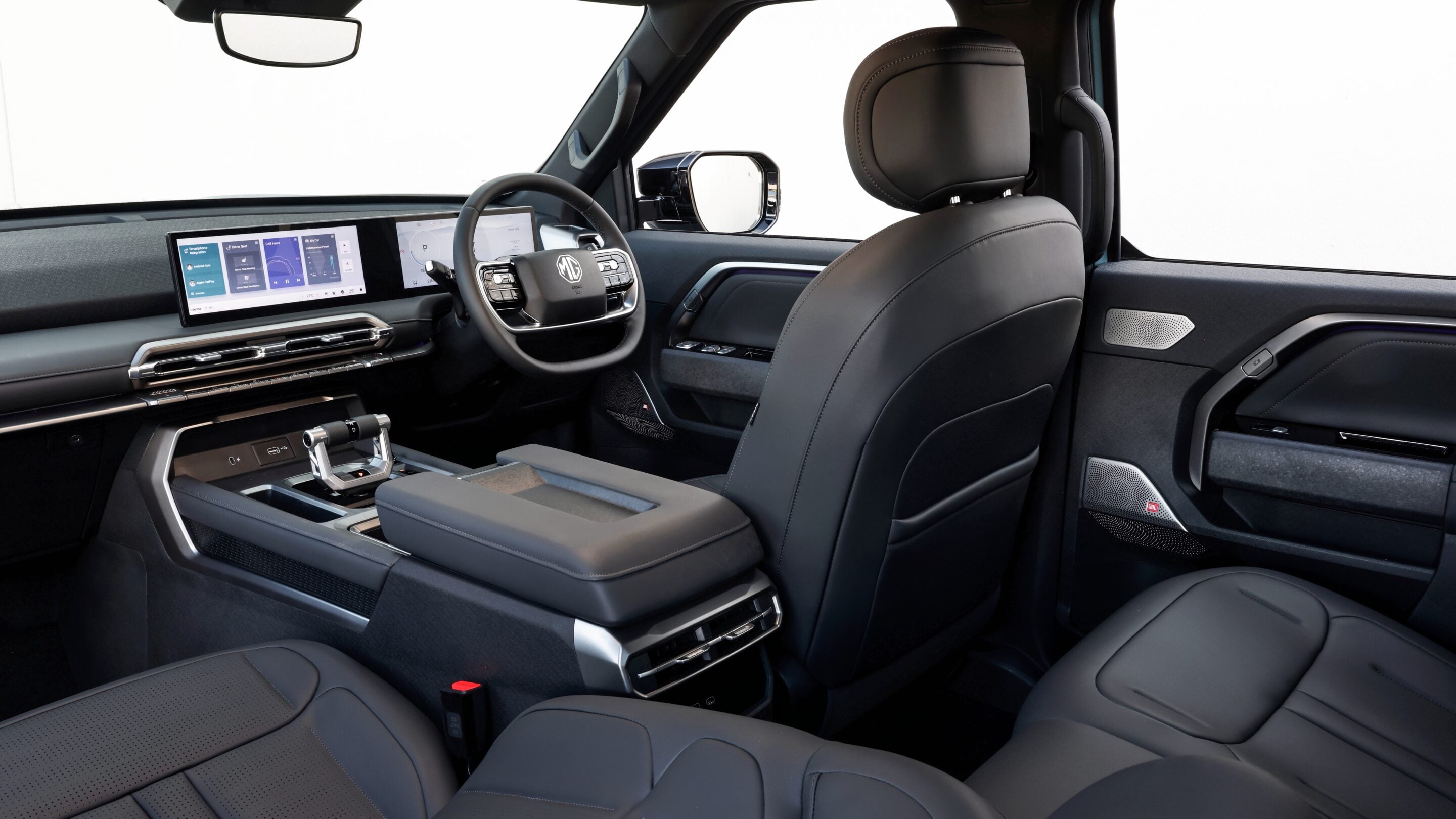 Luxurious car interior with black leather seats, a wide digital dashboard and large touchscreen infotainment screen.