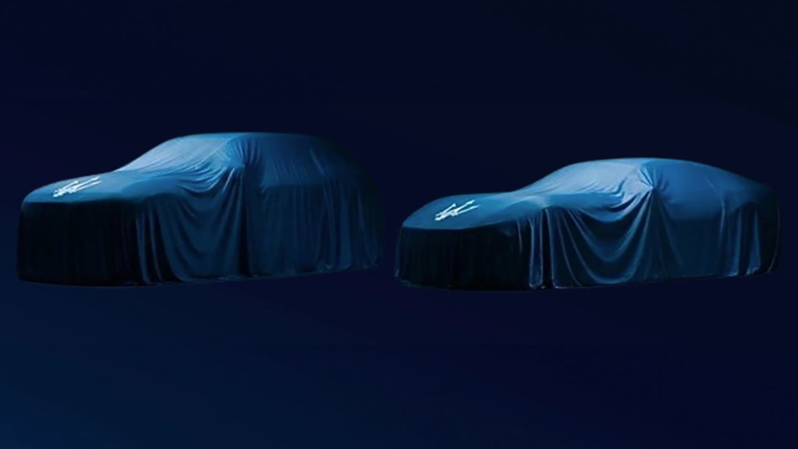 Two blue-covered cars parked side by side on a dark blue background.