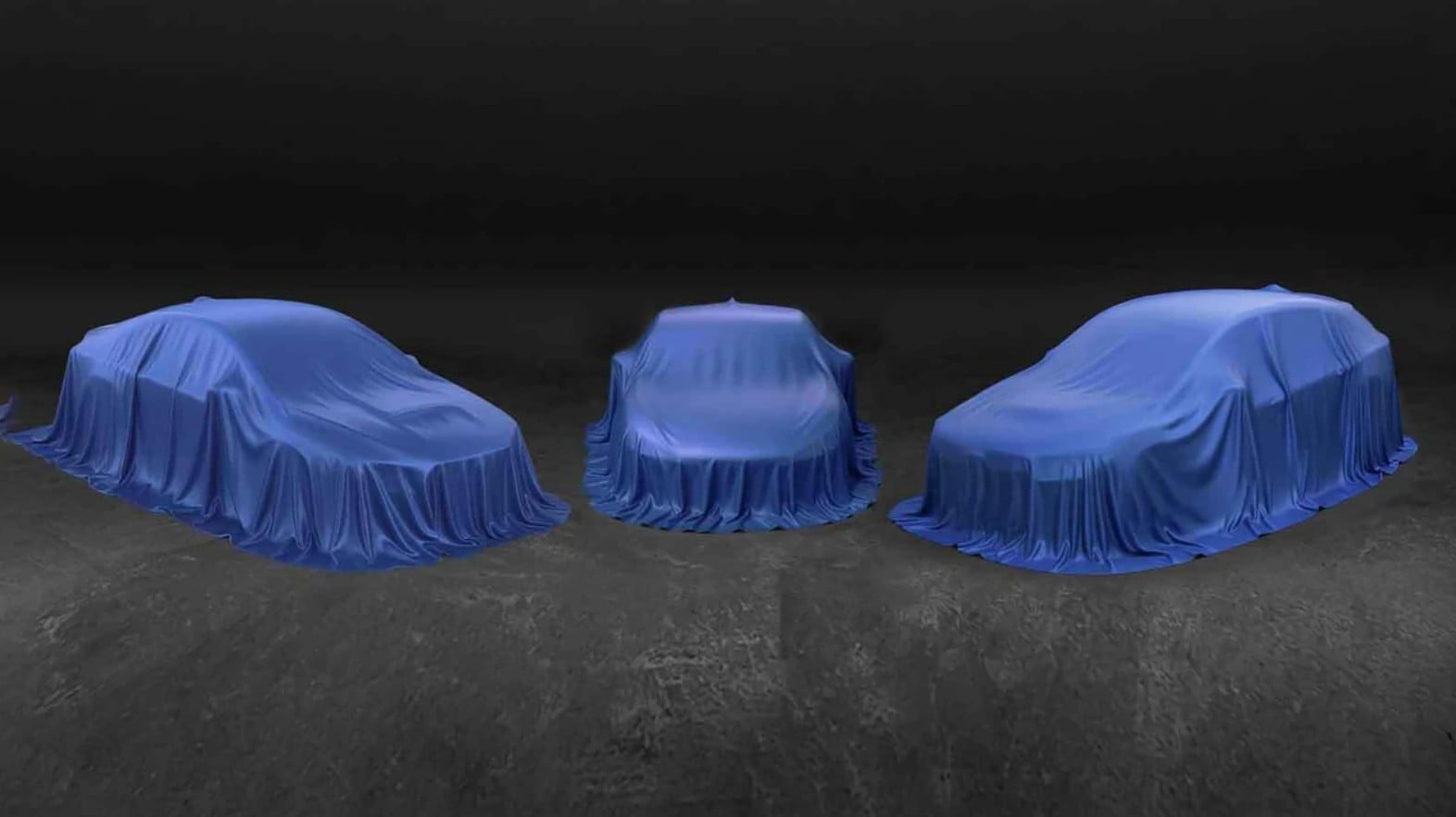 Three blue-covered cars lined up on a dark stage, awaiting reveal.