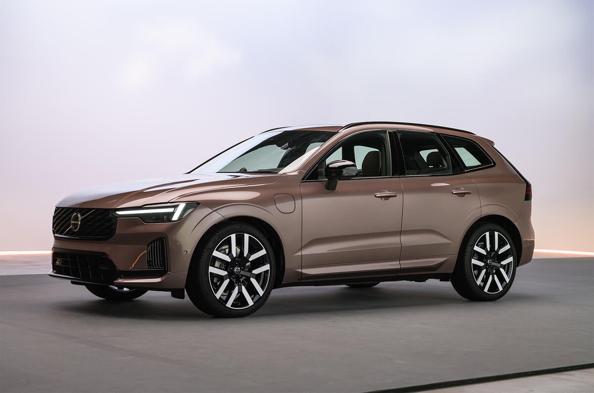 Brown Volvo SUV in a studio, front three-quarter view showing grille, LED headlights, and large multi-spoke wheels.