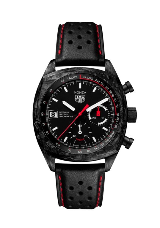 Close-up of a black TAG Heuer Monza chronograph watch with a perforated leather strap featuring red stitching and a tachymeter bezel.