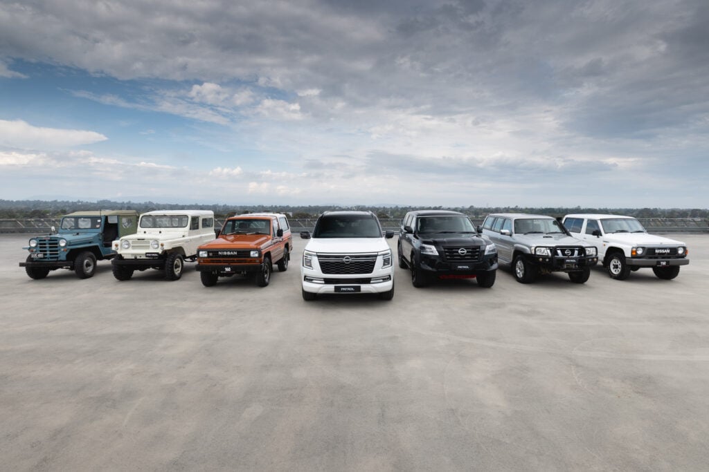 A row of seven Nissan Patrol vehicles on a carpark rooftop